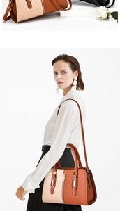 Detail of color-block tote bag featuring quilted texture and stylish metal accents