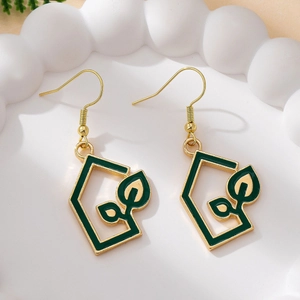 Detail shot of gold leaf earrings with green enamel house charms on white cloud tray