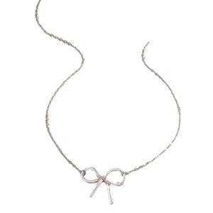 Minimalist silver bow pendant necklace with sleek metal lines on a white background
