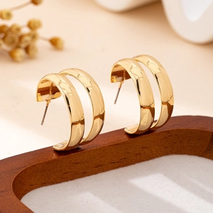 Polished gold double-row C-shaped hoop earrings with a modern minimalist design