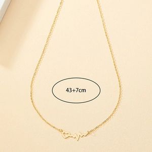 Detail view of gold EKG heart necklace showing 43cm chain and 7cm extension length