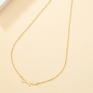 Golden heartbeat necklace with hollow heart pendant on a minimalist cream background