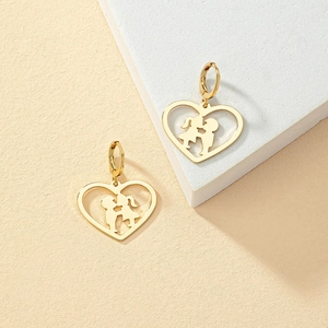 Golden heart earrings with boy and girl kissing silhouette on a geometric stand