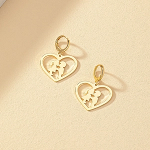 Detailed view of gold heart earrings featuring romantic kissing couple silhouette