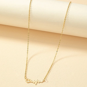 Gold heartbeat pulse and heart pendant necklace with O-chain on aesthetic pedestal