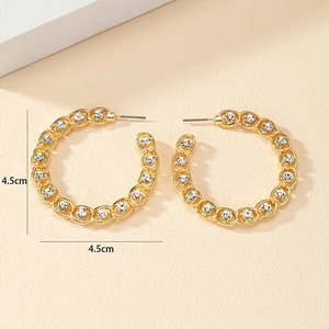 Detail view of gold C-shape hoop earrings with rhinestones and 4.5cm diameter measurement