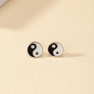 Minimalist silver-edged yin yang stud earrings with black and white enamel finish