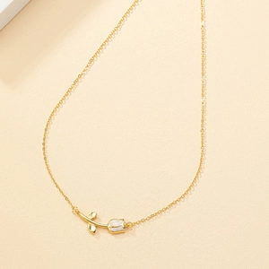 Elegant gold tulip necklace with white enamel petals and minimalist flower pendant