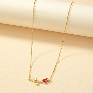 Elegant gold tulip pendant necklace with red enamel flower bud on a minimal display