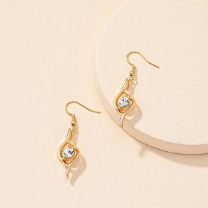 Elegant gold drop earrings with flame-shaped metal frame and sparkling zircon gemstone
