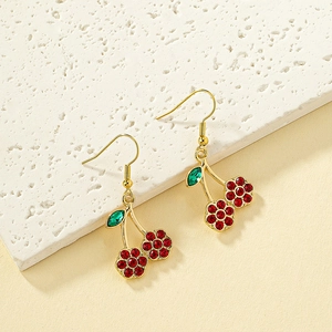 Elegant cherry drop earrings with red crystal clusters and green leaves on a stone tray