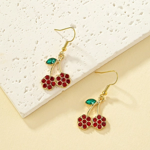 Fashionable cherry earrings with red and green rhinestones on elegant marble base