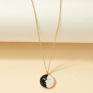 Retro gold coin necklace with artistic black and white enamel face pendant for women