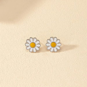 Minimalist white enamel daisy stud earrings with yellow center and silver finish