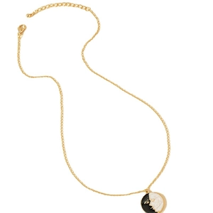 Retro gold chain necklace with a black and white enamel sun and moon face pendant