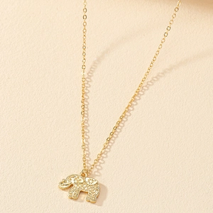 Golden necklace featuring a detailed hollow elephant pendant with traditional patterns