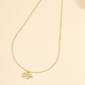 Vintage golden elephant pendant necklace with intricate floral engraving on a fine chain