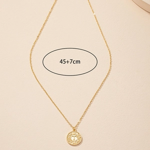 Macro shot of gold sun coin pendant necklace with 45cm chain and 7cm extender