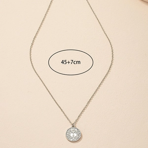 Detail of silver coin necklace showing 45+7cm chain length and sun pattern pendant