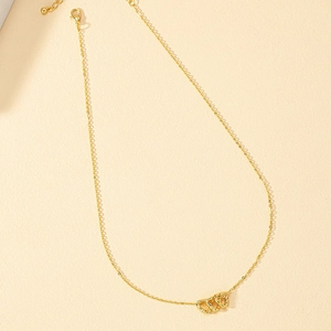 Minimalist gold necklace with three open heart pendants on a delicate link chain
