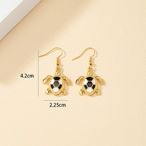Detail view of turtle drop earrings with black and white enamel shell, 4.2cm height