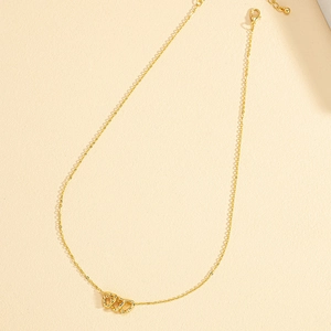 Minimalist gold necklace featuring three interlocking hollow heart-shaped pendants on fine chain