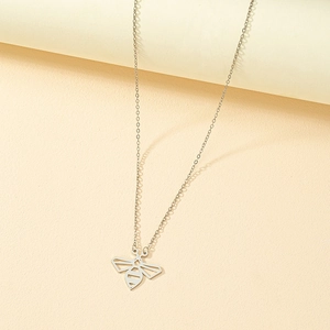 Minimalist silver bee pendant necklace with geometric hollow design on warm background