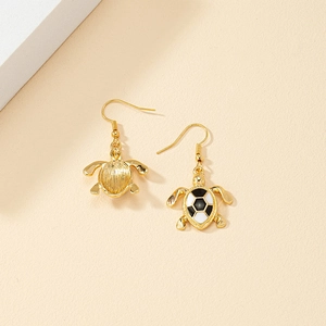 Golden sea turtle drop earrings with black and white enamel shell and hook closure