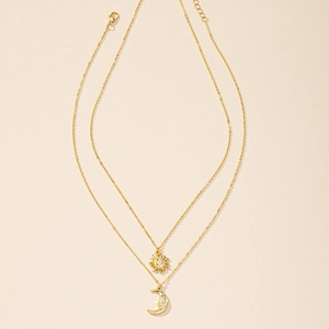 Golden sun and moon layered necklace set with adjustable lobster clasp on white background