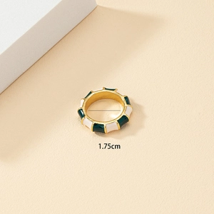 Close-up of bamboo-style gold ring with green and cream enamel and 1.75cm inner diameter