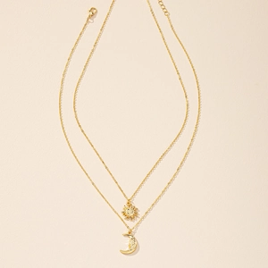 Golden double layer necklace featuring sun and crescent moon face pendants for women