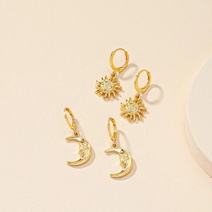Golden sun and moon face dangle earrings set with vintage celestial relief design