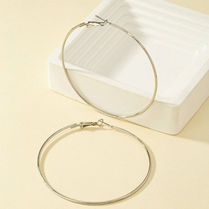 Minimalist silver geometric hoop earrings with slim design on aesthetic background