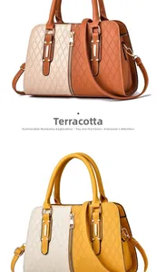 Detail view of contrast color handbag with diamond quilted stitching and perforated texture