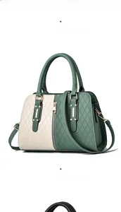 Detail view of matcha green and lemon yellow stitched handbag with gold hardware