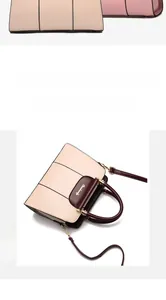 Detail of elegant two-tone faux leather handbag with gold metal twist lock and spacious interior