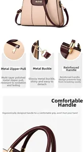 Detail view of reinforced handles and gold-tone hardware on minimalist beige tote bag