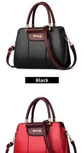 Close-up of leather shoulder bags in black and red with gold hardware and branding
