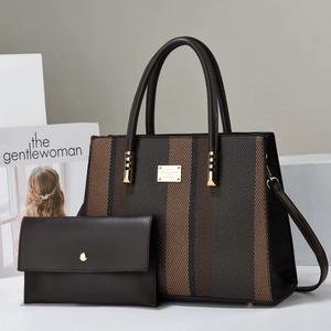 Detail of striped brown tote bag and matching envelope clutch with gold metal logo plaque