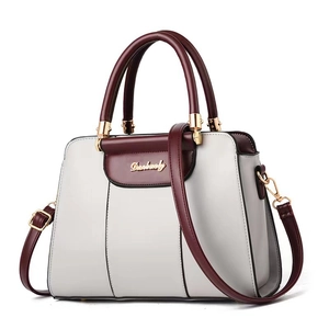 Elegant structured women's shoulder bag in contrast cream and burgundy faux leather