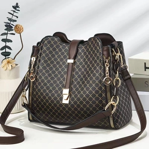Brown contrast print bucket bag with gold hardware and adjustable shoulder strap
