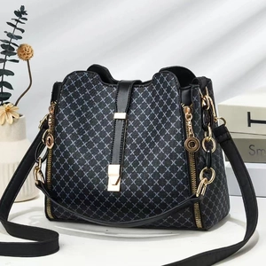 Detail of black bucket bag with gray geometric pattern and golden buckle hardware