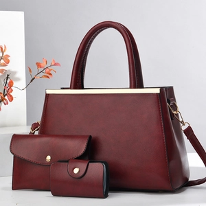 Three-piece burgundy faux leather tote set with crossbody bag and card holder
