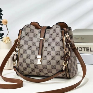 Detail of the high-quality buckle and brown monogram pattern on the bucket bag