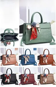Detail of stone pattern tote bag showing interior zip pocket and silk scarf decor