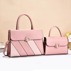 Pink faux leather handbag set with gold arched locks and adjustable shoulder straps