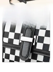 Macro view of textured quilted leather surface and silver circular metal buckle detail