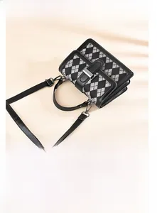 Detail shot of the houndstooth pattern bag with premium PU leather and silver metal buckle