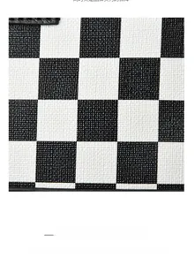 Macro detail of high-capacity black and white checkered bag with textured leather surface