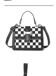 Front view of black and white checkered crossbody bag with silver buckle and leather handle